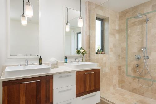 a bathroom with two sinks and a shower at 18 Kelly Isle in Long Bay Hills