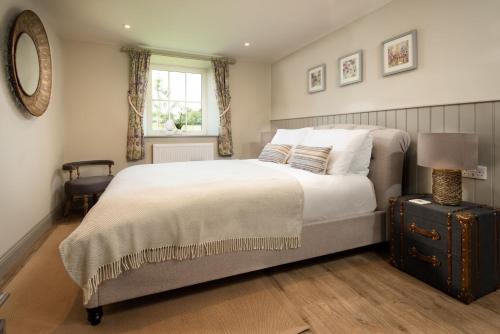 a bedroom with a large bed and a window at Overview Cottage in Belford