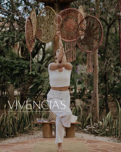 a woman is standing in front of some butterflies at Vila Cerrado in Alto Paraíso de Goiás