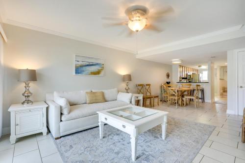 a living room with a couch and a table at St Augustine Poolside Oasis with Private Patio! in St. Augustine