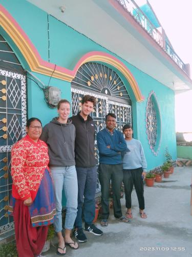 a group of people standing in front of a building at maa kalishila home stay in Ukhimath