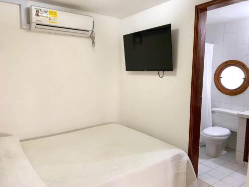 a small room with a bed and a tv at Nutilus Paraíso Marino Rodadero Sur in Gaira