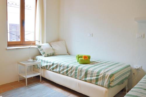 a small bed in a room with a window at Holiday Home Fisherman in Umag