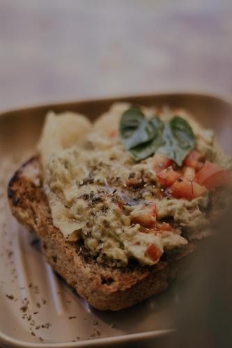 a piece of bread with vegetables on a plate at Vila Cerrado in Alto Paraíso de Goiás