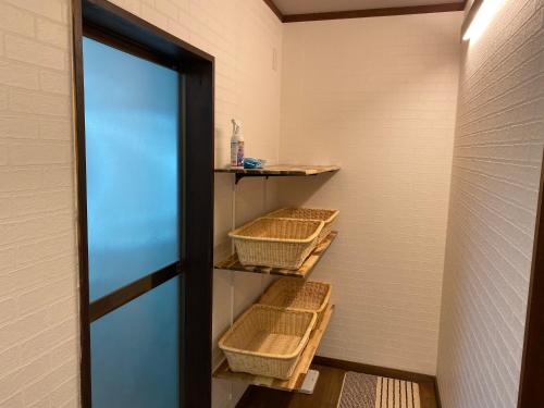 a locker room with baskets on the wall at Hakuba Goryu Pension Kurumi in Hakuba