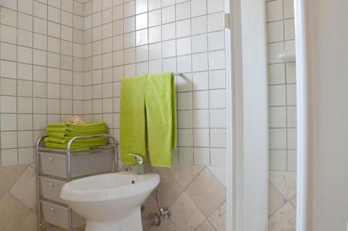 a bathroom with a toilet and a green towel at Holiday Home Fisherman in Umag