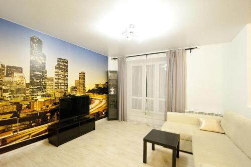 a living room with a large mural of a city at City Centre Vip 202 in Tbilisi City