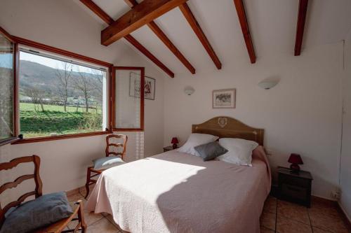 Un dormitorio con una cama y una ventana grande en Goiz-izarra, en Saint-Martin-dʼArrossa