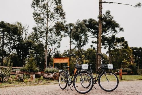 two bikes parked next to each other in a park at WoodStone Hotel Fazenda in Gramado