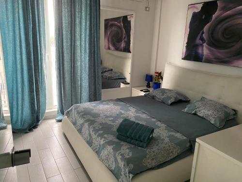a bedroom with a large bed with blue curtains at Blue light ultracentral in Craiova
