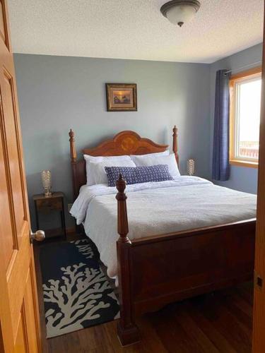 a bedroom with a bed with a wooden head board at Beautifully Furnished 5-Bedroom in Rochester