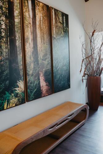 a room with three paintings on the wall at WoodStone Hotel Fazenda in Gramado