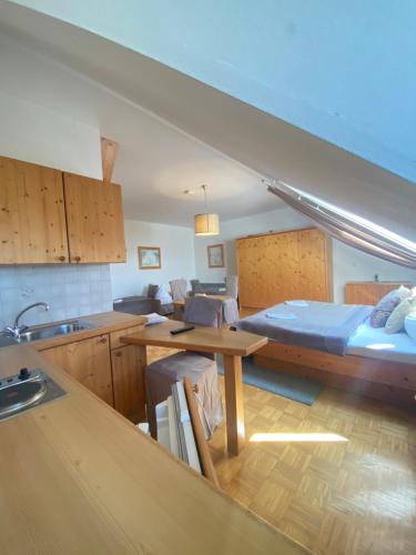 a kitchen with a bed and a table in a room at Pension Rucksackpeter in Hohenbrugg an der Raab