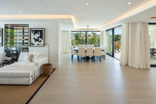 a living room with a white couch and a table at Villa Mercedes - Luxury 5-Bedroom Villa in Las Brisas, Marbella in Marbella