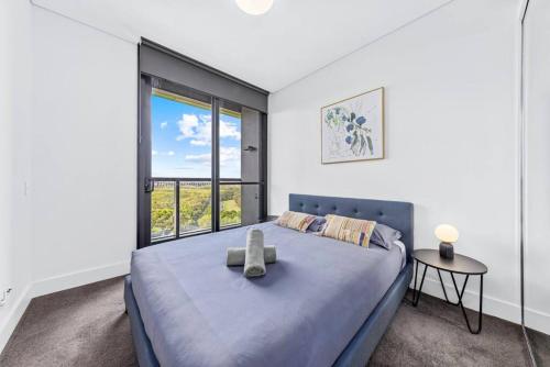 a bedroom with a large bed and a window at Warm and cozy 3 Bed APT in Sydney