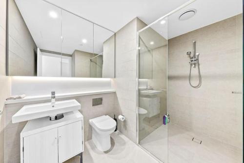 uma casa de banho com um lavatório e um chuveiro. em Warm and cozy 3 Bed APT em Sydney