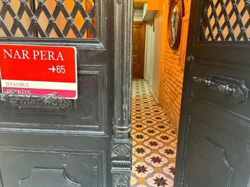 a black door with a sign on the door at NarPera Taksim Boutique Hotel in Istanbul