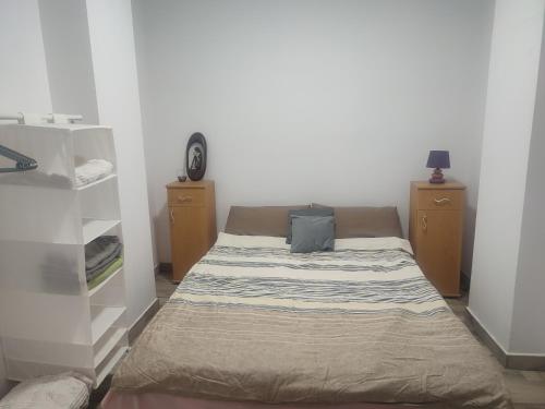 a small bed in a room with two night stands at Apartament Karina in Baia Mare