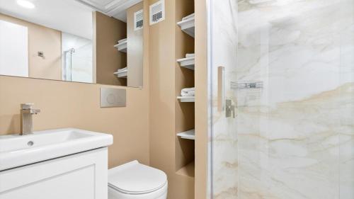 a bathroom with a shower with a toilet and a sink at Tides Miami 2BR Condo on the beach in Hollywood