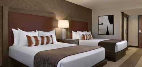 a hotel room with two beds and two lamps at Santa Fe Station Hotel & Casino in Las Vegas