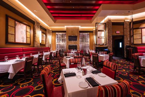 a restaurant with white tables and red chairs at Santa Fe Station Hotel & Casino in Las Vegas