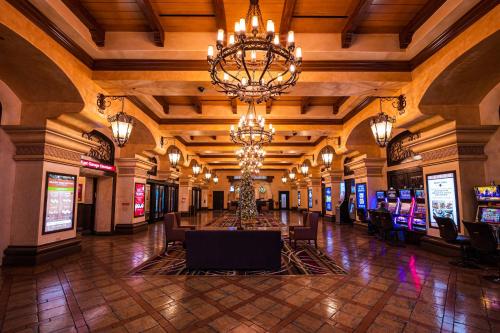a lobby with a large chandelier and slot machines at Santa Fe Station Hotel & Casino in Las Vegas