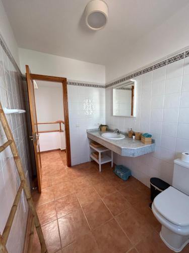 a bathroom with a sink and a toilet at Casa Oona in Playa Blanca