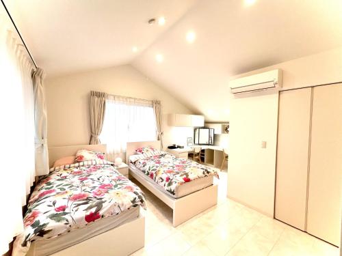 um quarto com 2 camas e uma janela em Bell house em Tóquio