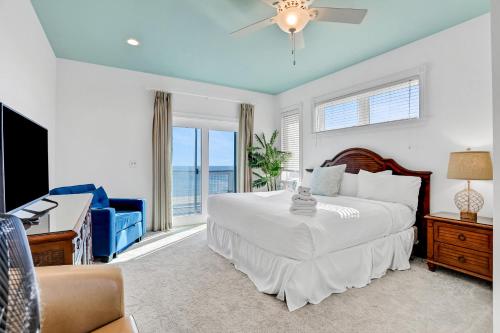 a bedroom with a bed and a couch and a television at Valhalla in St. George Island