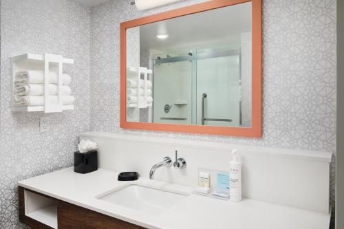 a bathroom with a sink and a mirror at Hampton Inn Melbourne-Viera in Melbourne
