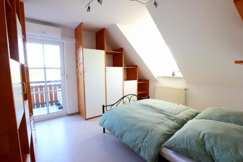 a bedroom with a bed and a large window at Ferienwohnung zur Bugspitze in Selbitz