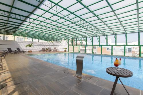 a large swimming pool with a large glass ceiling at Faro Hotel Atibaia in Atibaia
