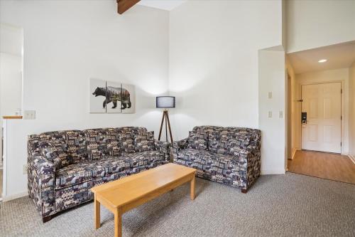 a living room with a couch and a table at Cedarbrook Deluxe Two Bedroom Suite with outdoor heated pool 10304 in Killington