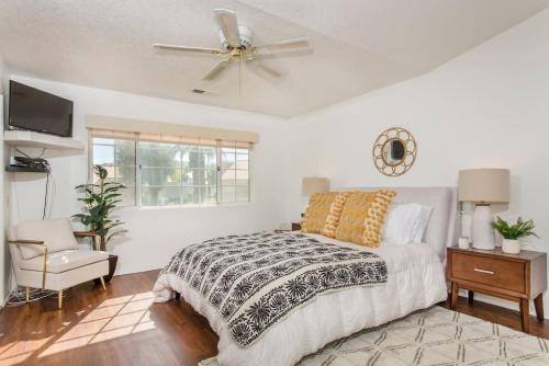 a bedroom with a bed and a ceiling fan at BEAUTIFUL Palm Desert OASIS 2bd 2ba GETAWAY in Palm Desert