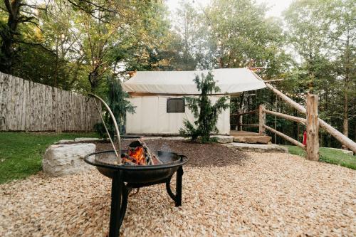 a fire pit in a yard next to a house at The Original Campsite on 53 acres, Branson, MO in Branson