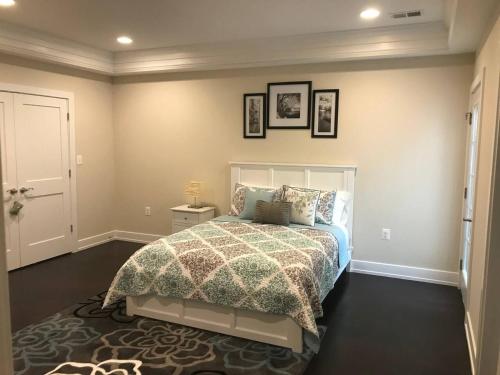 a bedroom with a bed with a comforter on it at Entire Extra Large Luxury 3 Bedrooms Condo in Washington