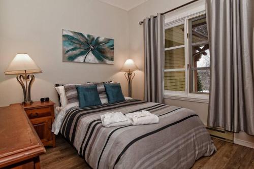 - une chambre avec un lit et des serviettes dans l'établissement Plateau B - Mont-Tremblant, à Mont-Tremblant