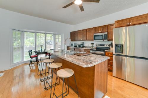 a kitchen with a large island with bar stools at Lake Escape in Cadiz with Dock Families Welcome! in Cadiz