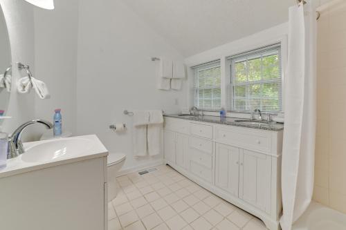 a white bathroom with a sink and a toilet at Lake Escape in Cadiz with Dock Families Welcome! in Cadiz