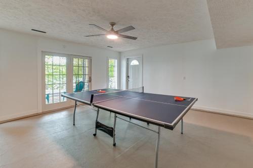 a ping pong table in a room with a ceiling fan at Lake Escape in Cadiz with Dock Families Welcome! in Cadiz
