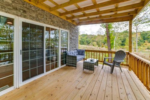 a porch with a couch and chairs on a wooden deck at Lake Escape in Cadiz with Dock Families Welcome! in Cadiz
