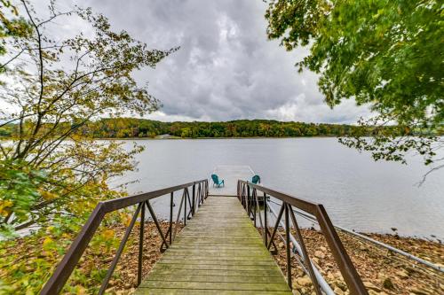a dock with a boat on a lake at Lake Escape in Cadiz with Dock Families Welcome! in Cadiz