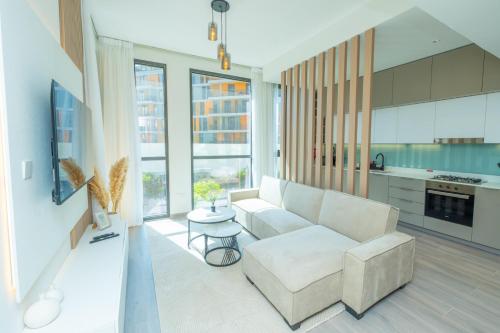 a living room with a couch and a table at Midtown Haven Cozy One Bed in Dubai in Dubai