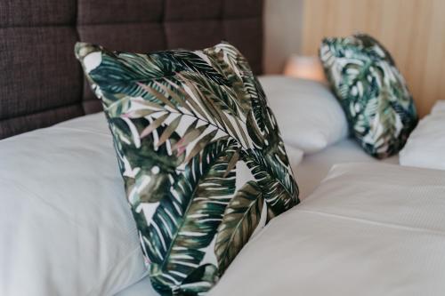 two pillows sitting on top of a bed at RELAX APARTMENTS An der Lage Hochgraßnitzberg in Spielfeld