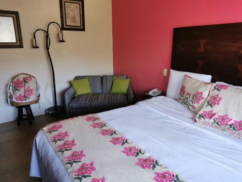 a bedroom with a bed and a couch at Hotel San Jorge in Tlatlauquitepec