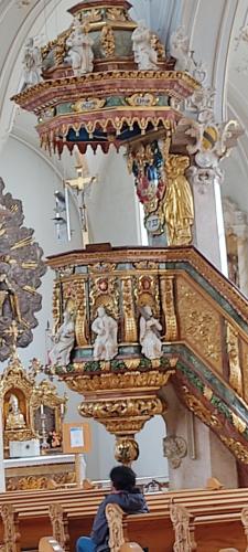 a person standing in front of a shrine in a church at Gite 3 Frontières in Hagenthal-le-Bas