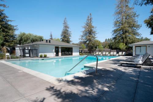 a swimming pool with a house and trees at Cupertino 2br w pool ac nr shops dining SFO-1437 in Cupertino