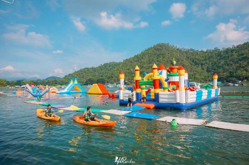 a group of people in kayaks in a body of water with play equipment at เดอะวอเตอร์ปาร์ครีสอร์ท- The Water Park Resort in Ban Laem Mong Khoi