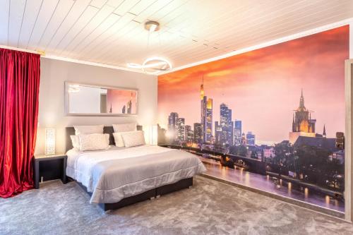 a bedroom with a large mural of a city at PMC Business Apartments in Rüsselsheim