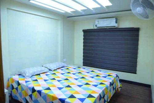 a bedroom with a colorful bed in a room at Spice coast cruise in Kokkānisseri